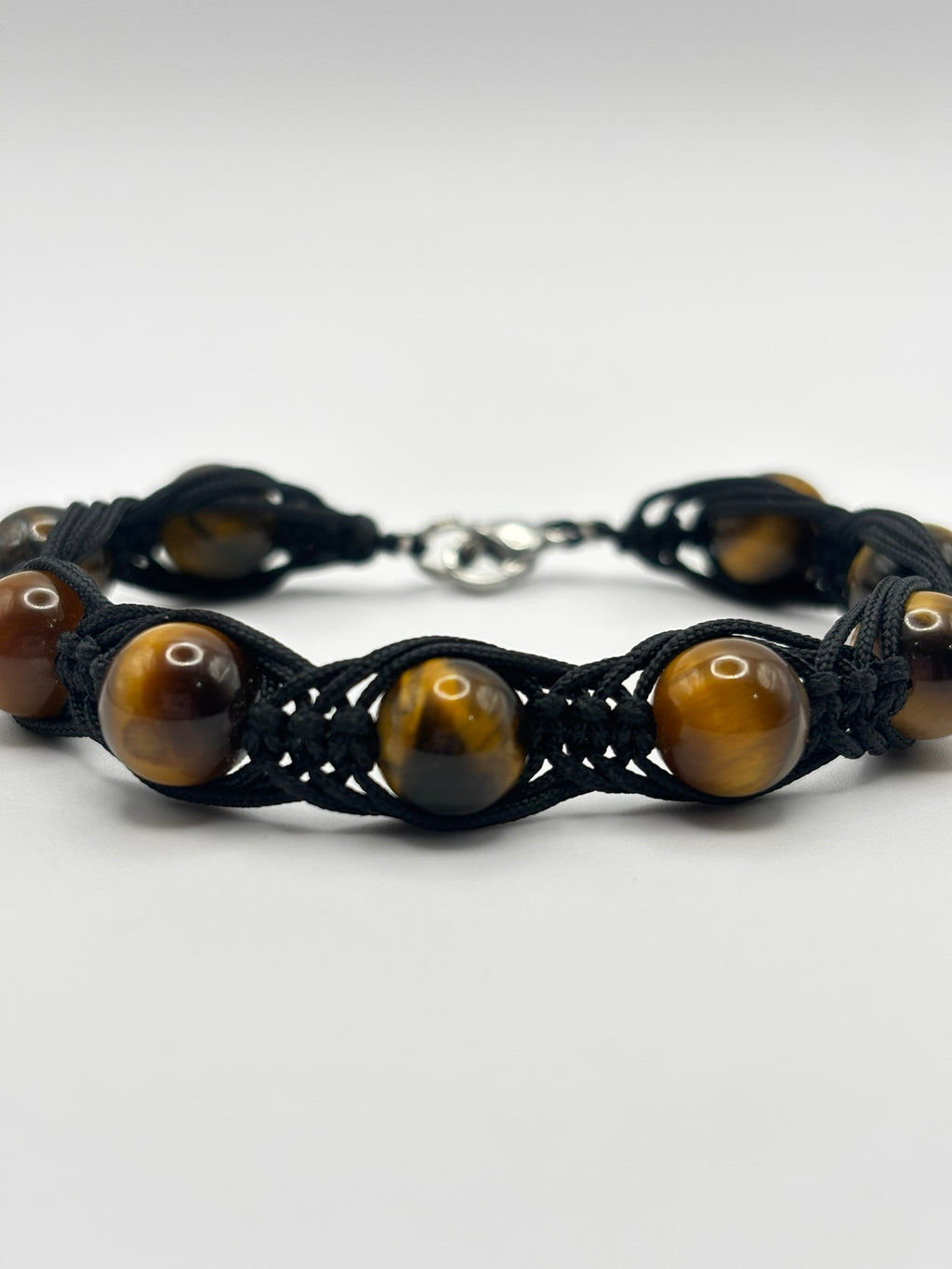 Pulsera de Ojo de Tigre con Tejido Trezado– Protección, Confianza y Fuerza Interior